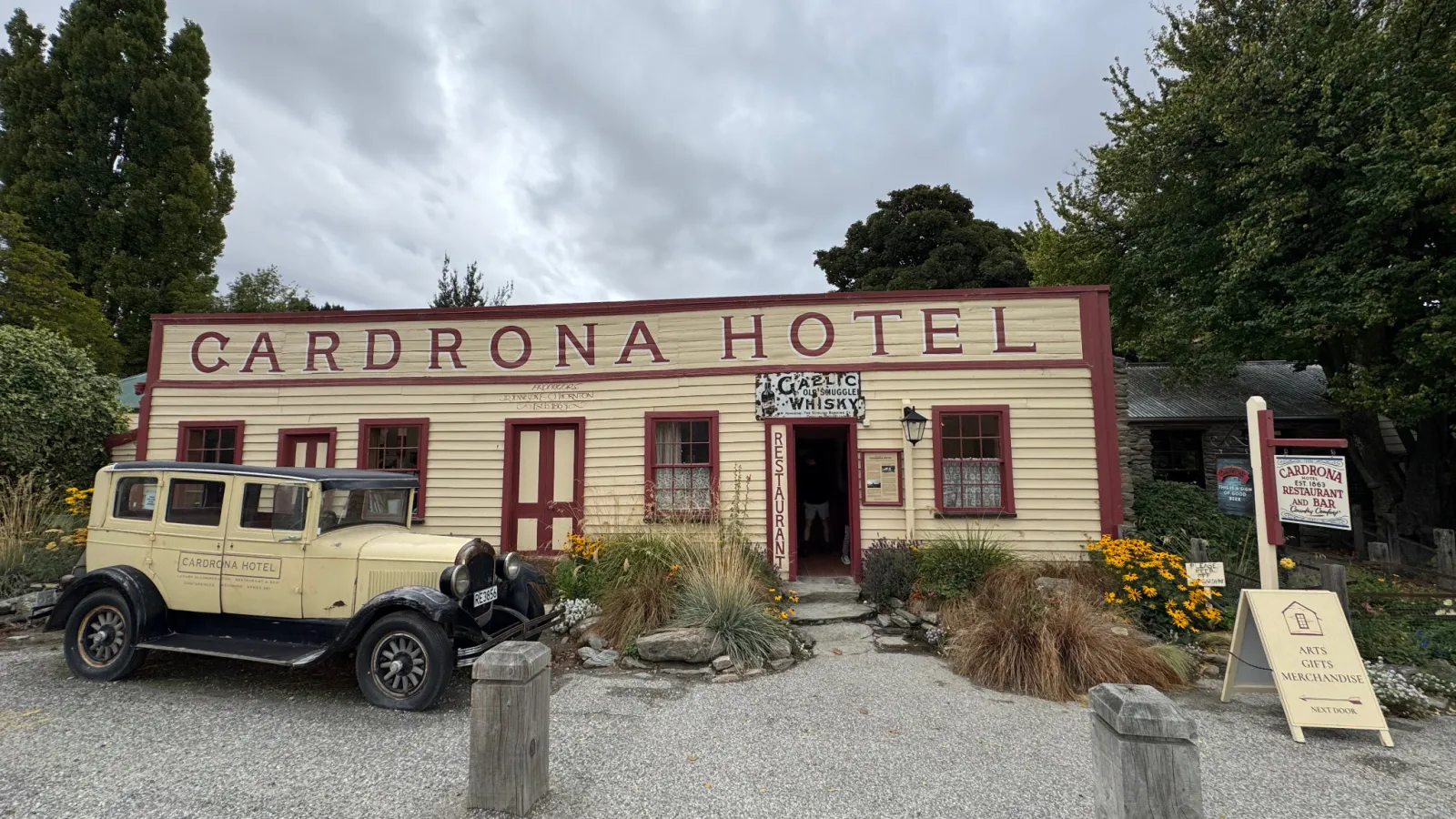 The historic Cardrona Hotel, with a vintage car parked in front.