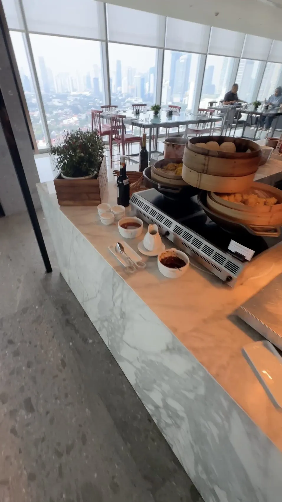 Breakfast buffet: bamboo steamers alongside the skyline views.