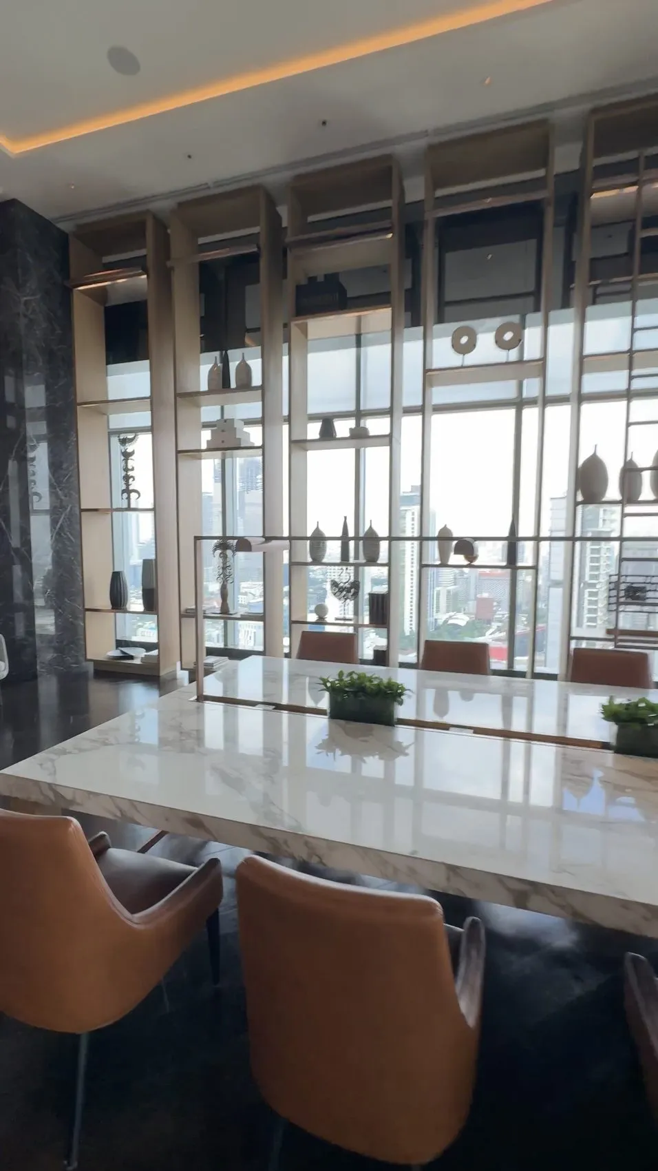 One of the hotel’s inviting common spaces, framed by Jakarta views.